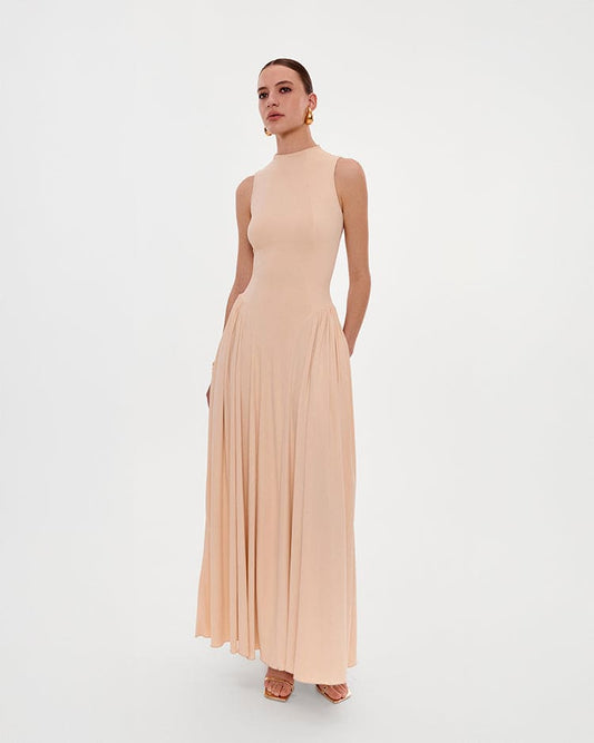 NUDE SLEEVELESS MOCK NECK DRESS WITH A PLEATED MAXI SKIRT